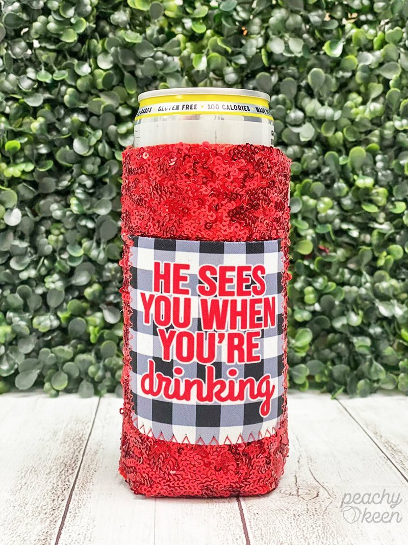 PEACHY KEEN PEACHY KEEN HE SEES YOU WHEN YOU'RE DRINKING SEQUIN CAN COOLERS FOR SLIM CAN